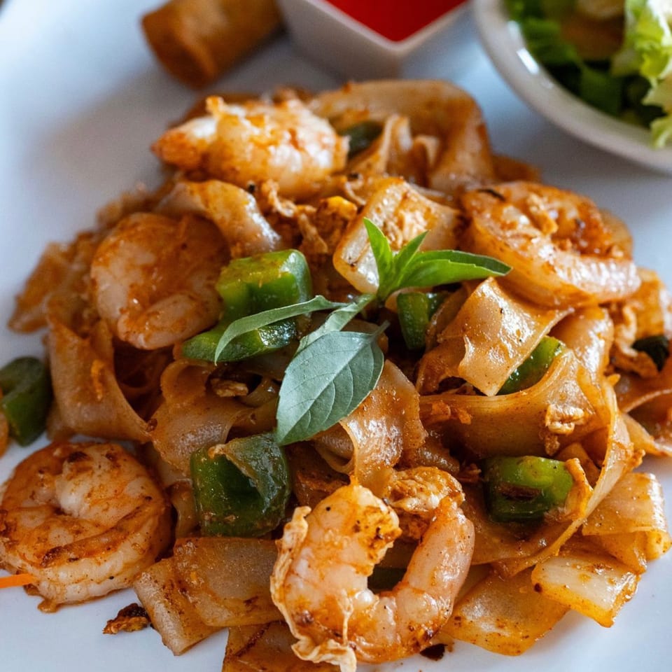 Kanda Thai Cuisine's Pad See Ew with shrimp, wide noodles, green bell peppers, and basil.